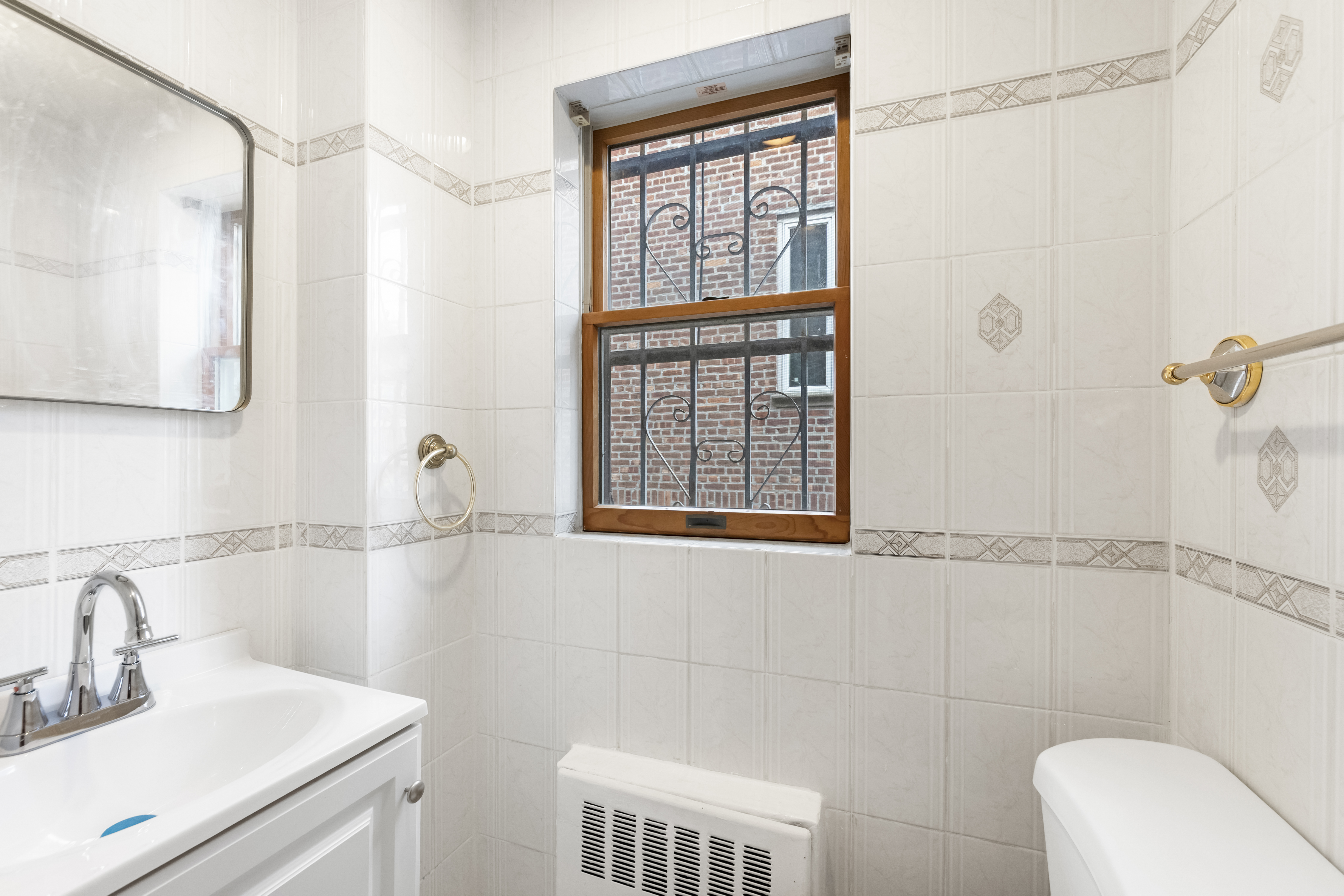 185 Oxford Street Brooklyn, NY 11235 - Photo 15 of 17 a bathroom with a sink and a toilet