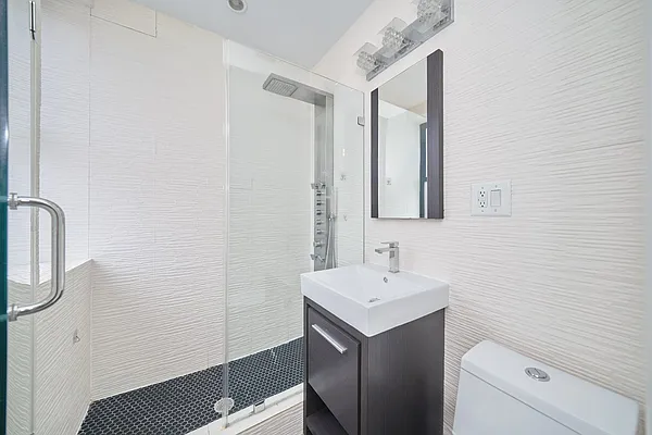 20 Avenue A, Unit 5E Manhattan, NY 10009 - Photo 5 of 7 a bathroom with a sink and a mirror