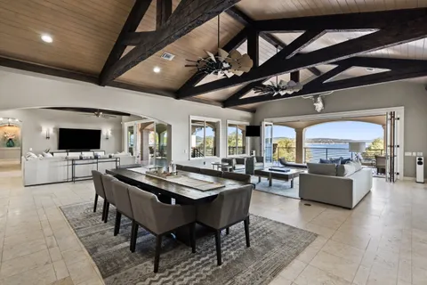 a living room with fireplace furniture and a large window