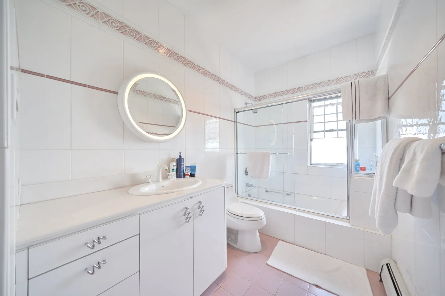 a bathroom with a granite countertop sink mirror vanity bathtub and shower