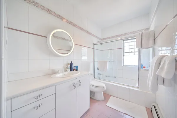 a bathroom with a granite countertop sink mirror vanity bathtub and shower