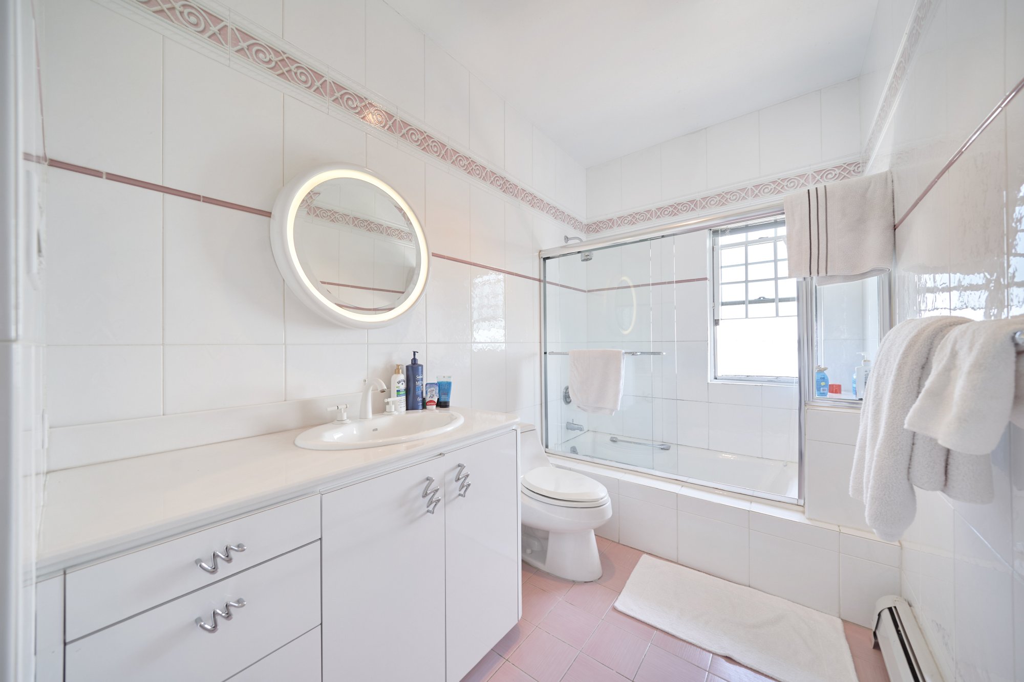 3411 Country Club Road Bronx, NY 10465 - Photo 30 of 54 a bathroom with a double vanity sink toilet mirror and bathtub