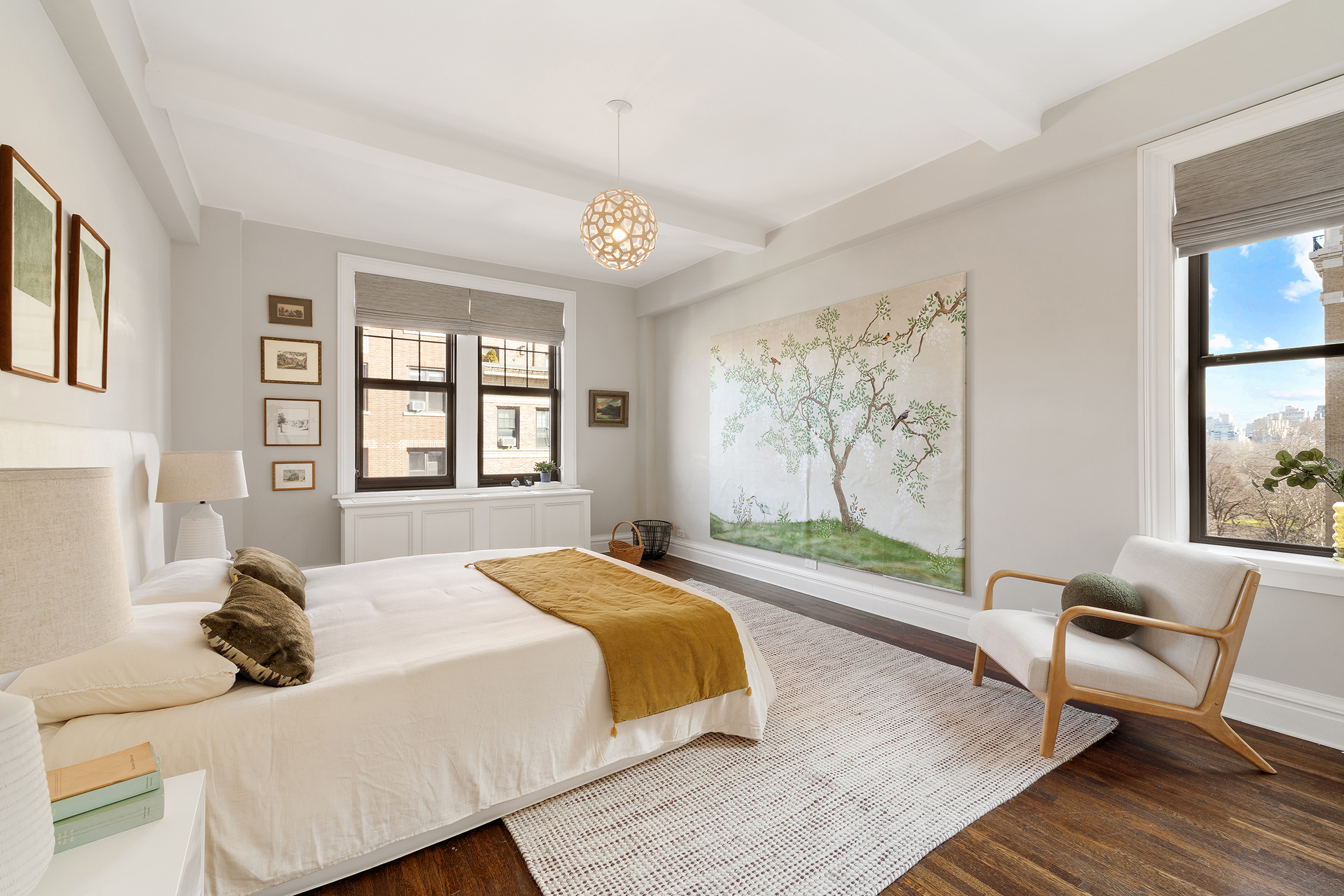 24 West 69th Street, Unit 9A Manhattan, NY 10023 - Photo 7 of 14 a bedroom with a bed and wooden floor