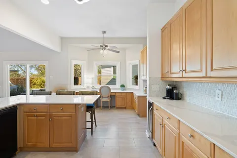 a large kitchen with kitchen island a sink a center island and a window