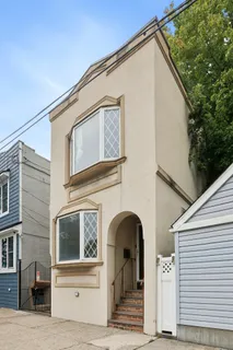 a front view of a brick house with a bench
