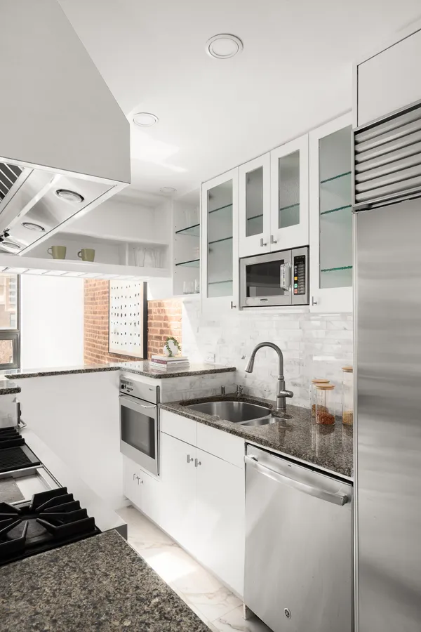 a kitchen with stainless steel appliances granite countertop a sink stove and cabinets