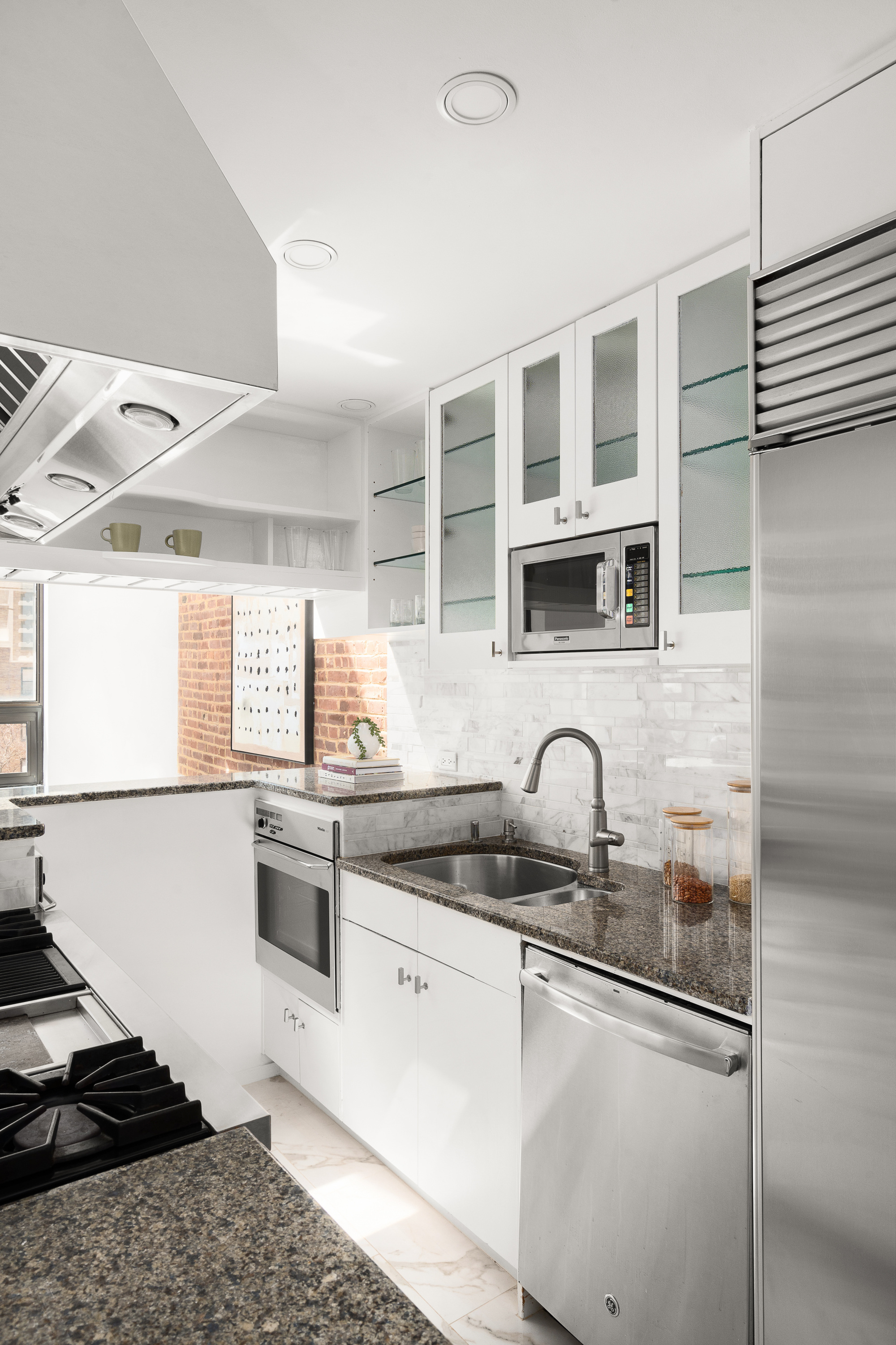 342 West 85th Street, Unit PH6AB Manhattan, NY 10024 - Photo 7 of 17 a kitchen with stainless steel appliances granite countertop a sink stove and cabinets