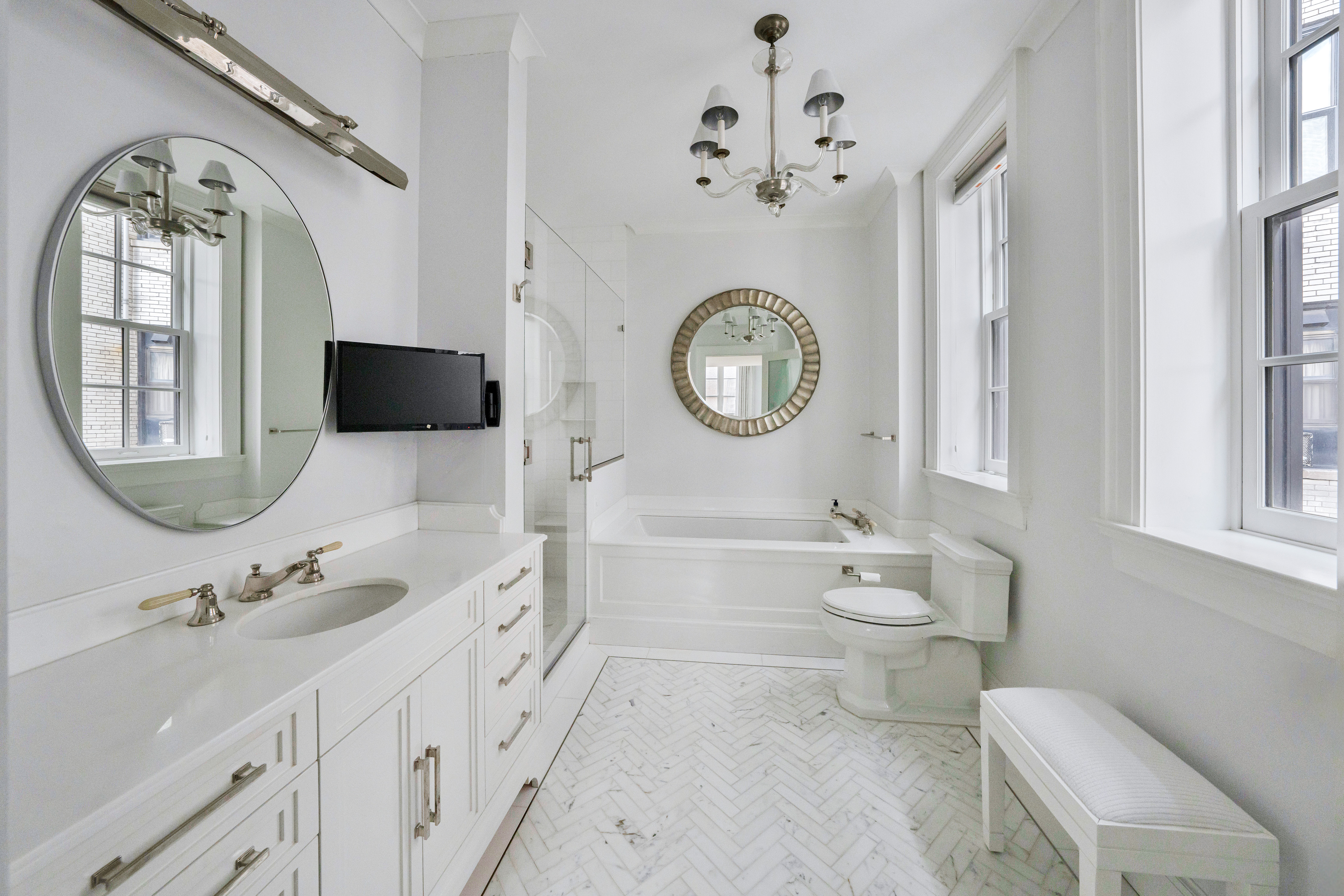 850 Park Avenue, Unit 9C Manhattan, NY 10075 - Photo 10 of 14 a bathroom with a toilet a sink and a mirror