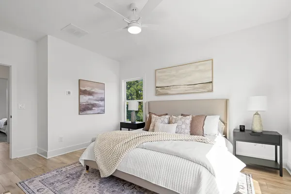 a bedroom with a bed and a painting on the wall