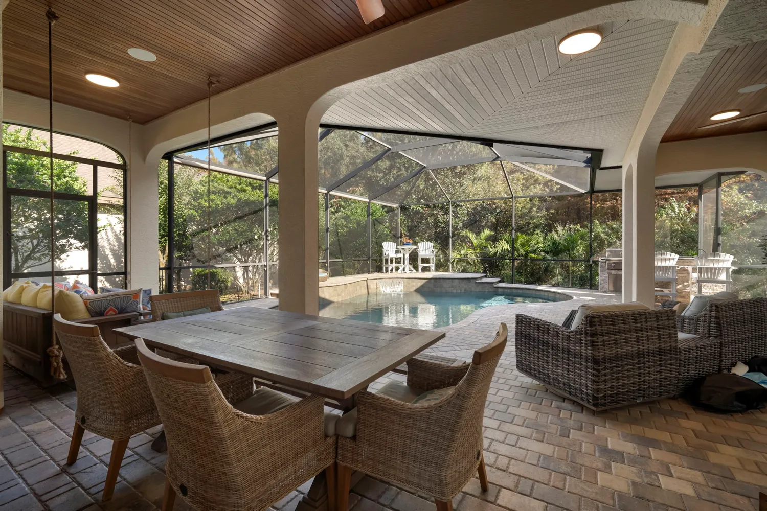 a view of a dining room with furniture large windows and wooden floor