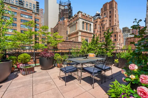 a view of a patio with table and chairs and potted plants