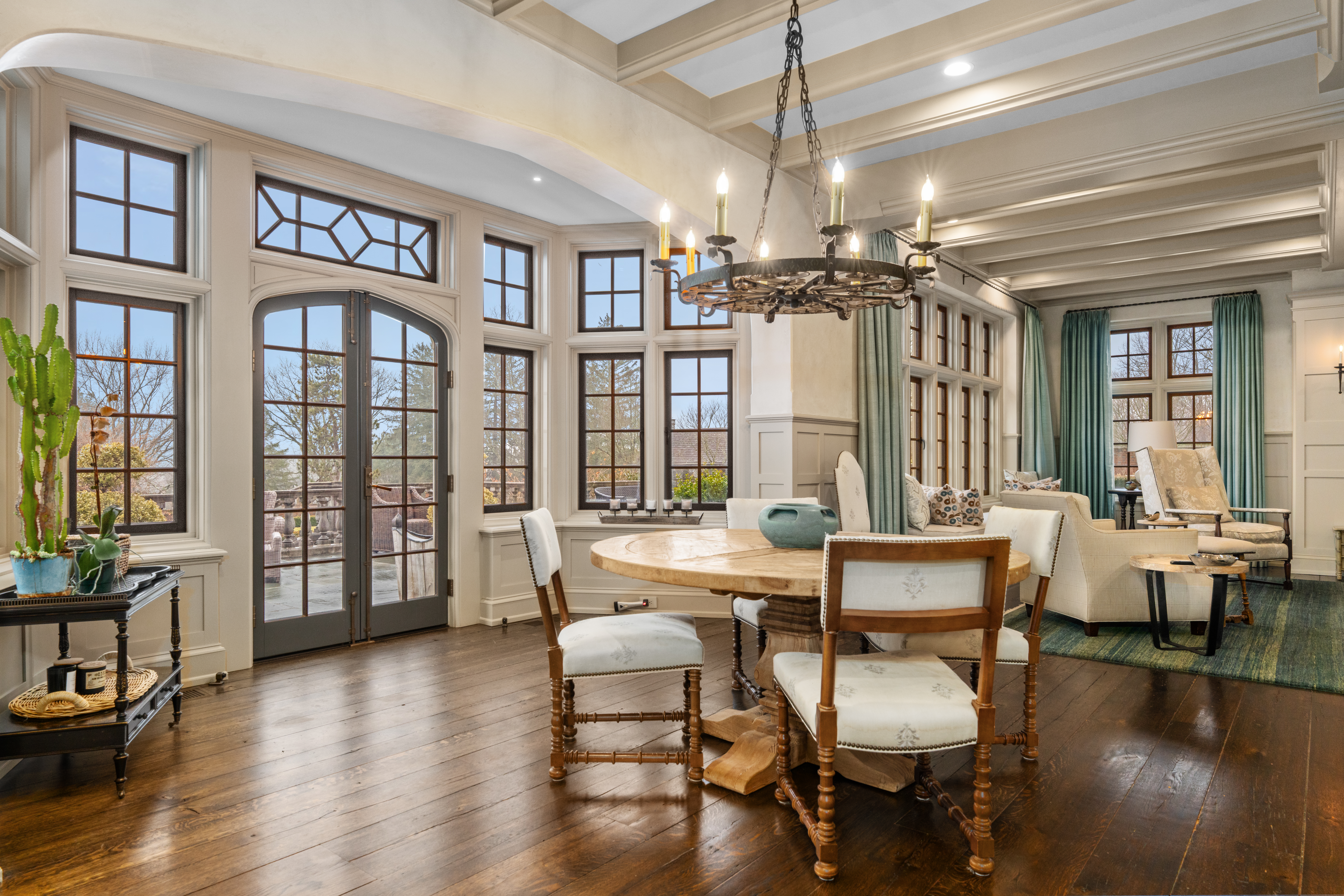 1033 Sugartown Road Berwyn, PA 19312 - Photo 15 of 53 a dining room with wooden floor a chandelier a glass table and chairs