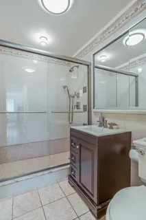 a bathroom with a double vanity sink mirror and toilet
