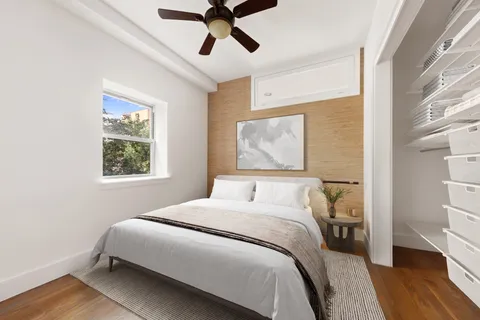 a bedroom with a bed and wooden floor