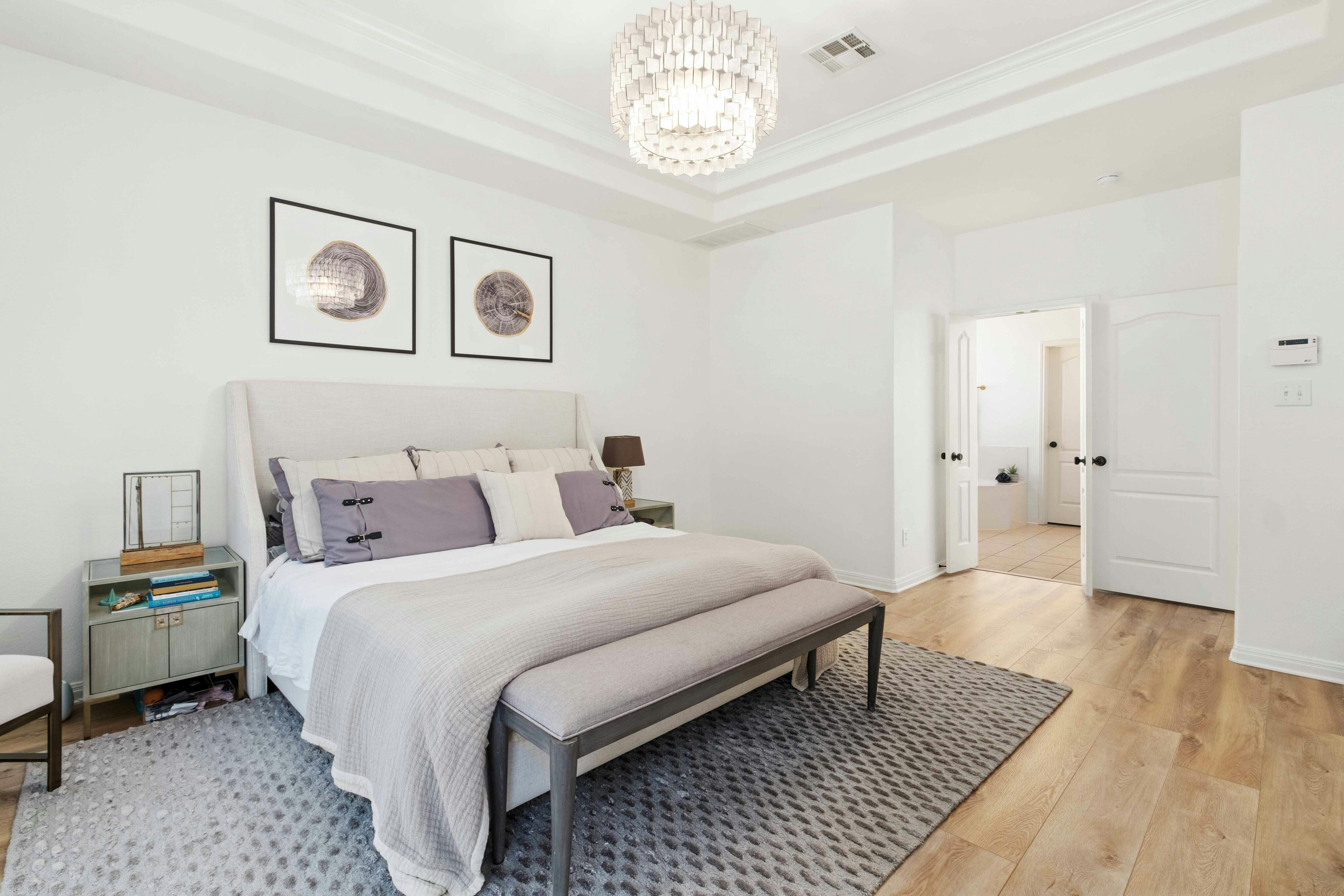 10608 Pointe View Drive Austin, TX 78738 - Photo 17 of 46 a bedroom with a bed and a table with wooden floor