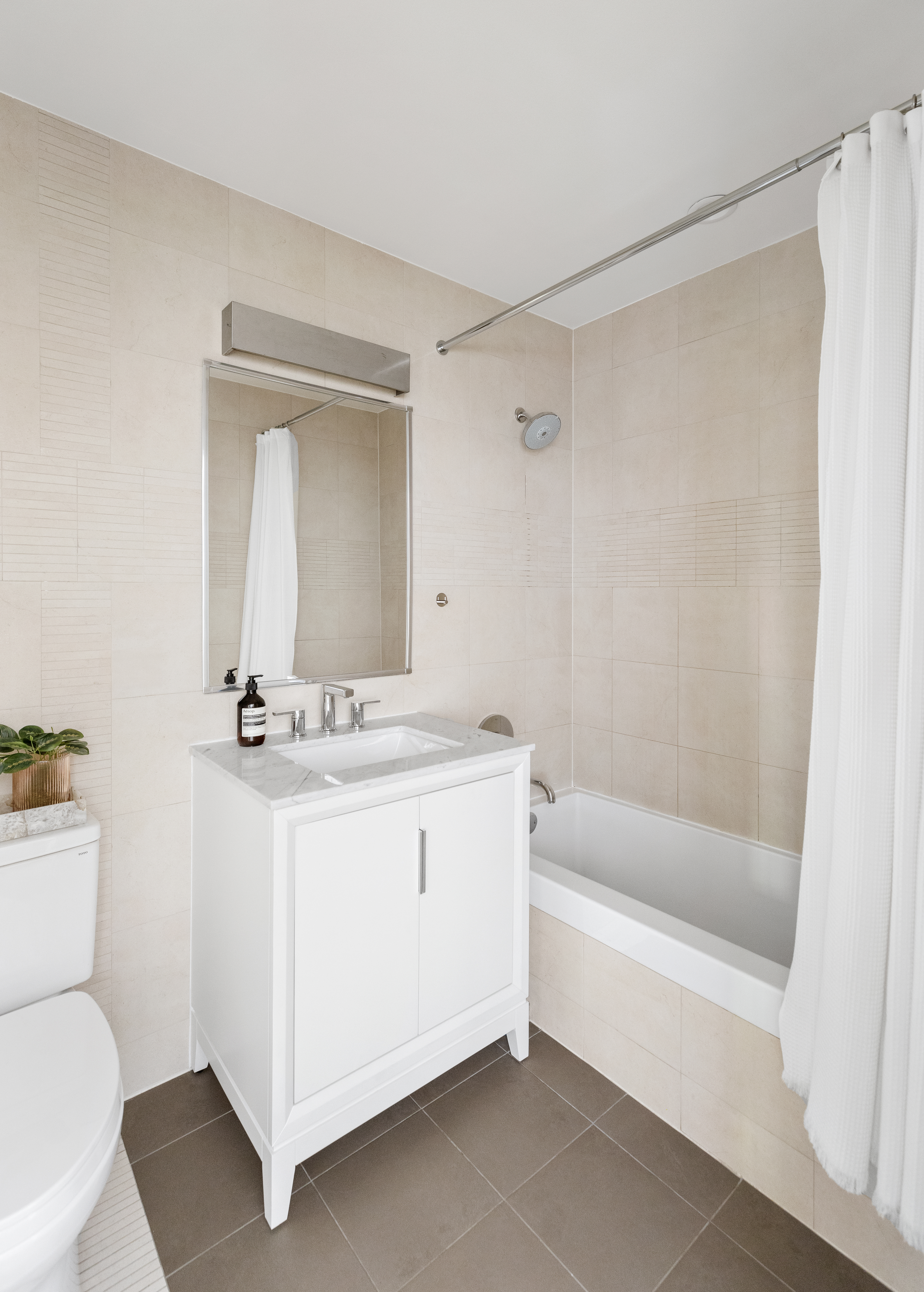 110 Warren Street, Unit B203 Brooklyn, NY 11201 - Photo 6 of 10 a bathroom with a sink a toilet and a bathtub