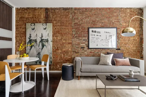 a living room with furniture and wall paintings