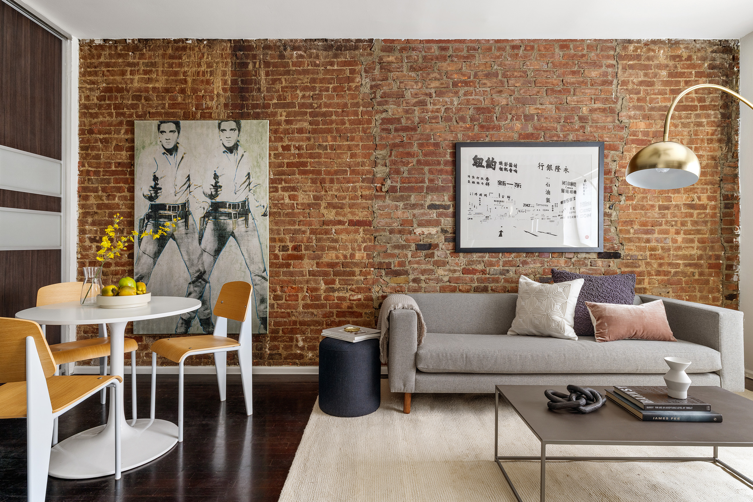 207 East 21st Street, Unit 2A Manhattan, NY 10010 - Photo 1 of 7 a living room with furniture and wall paintings