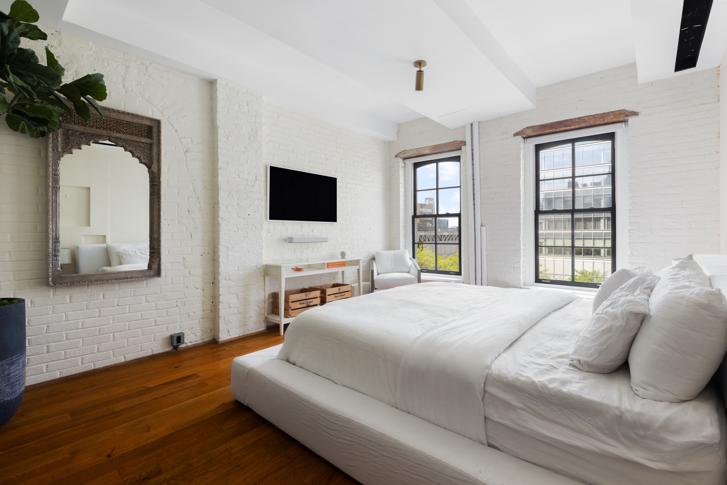 62 Beach Street, Unit 5E Manhattan, NY 10013 - Photo 8 of 15 a bedroom with a bed and a flat screen tv