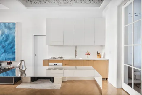 a room with a couch and cabinets