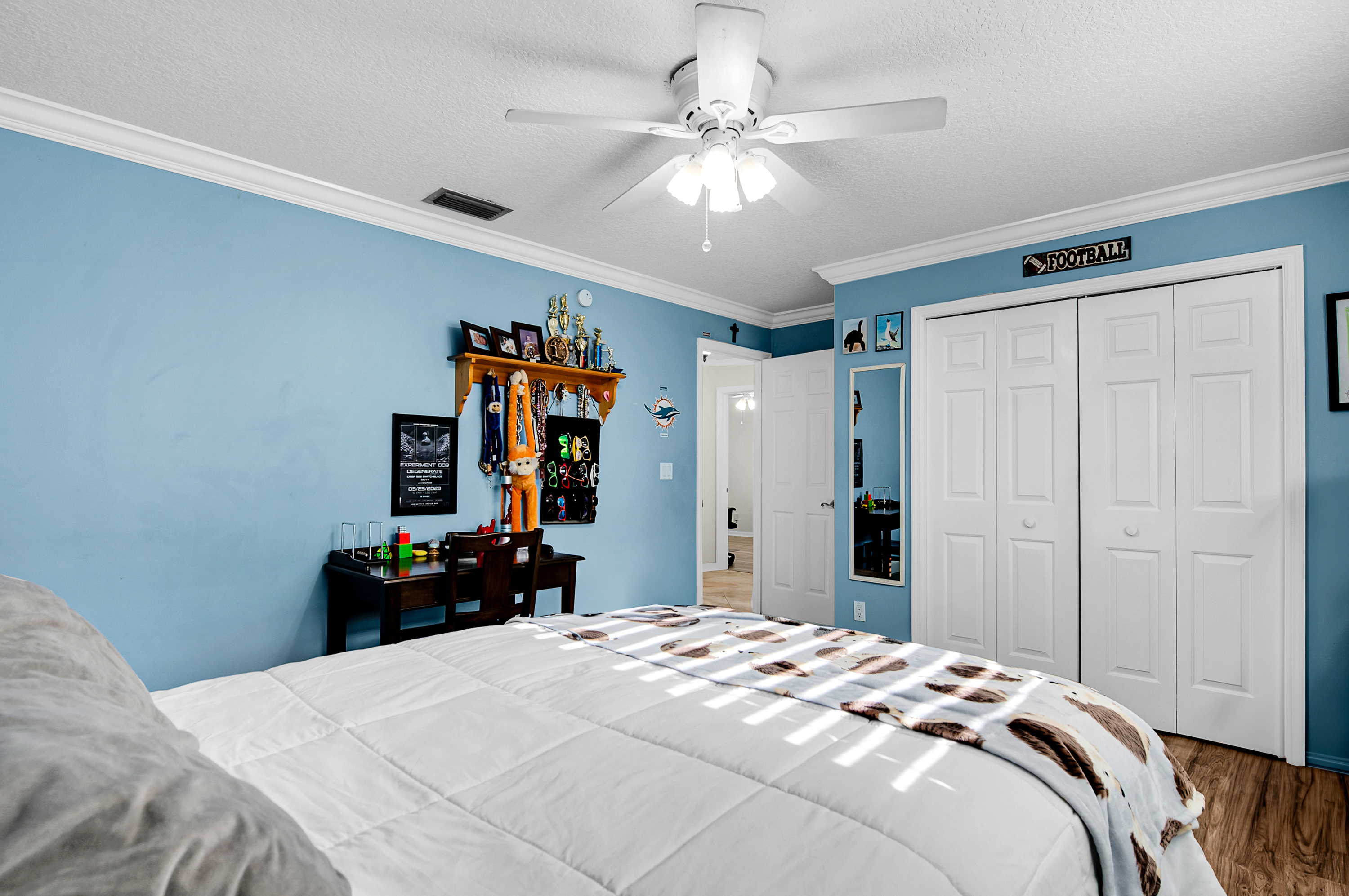 1560 Southwest 16th Street Boca Raton, FL 33486 - Photo 55 of 72 a bedroom with bed and a chandelier