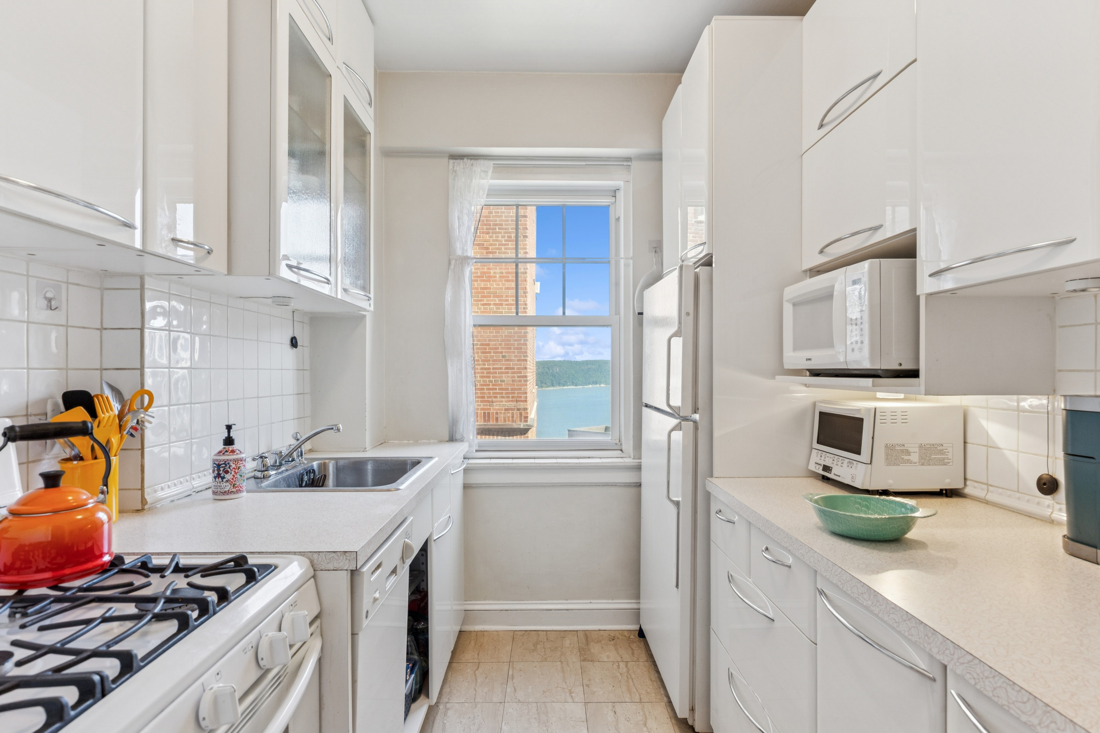 200 Cabrini Boulevard, Unit 47 Manhattan, NY 10033 - Photo 5 of 20 a kitchen with stainless steel appliances a sink a stove and a refrigerator