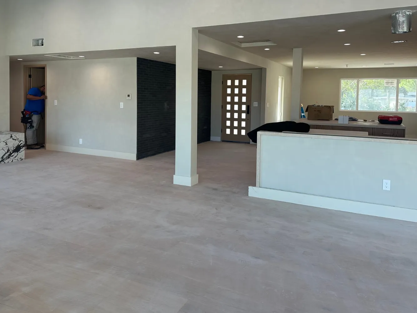 an empty room with a cabinet and mirrors