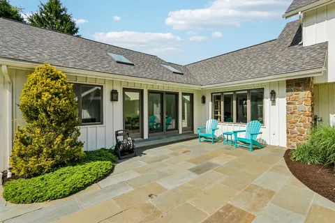 a view of a house with sitting area and garden