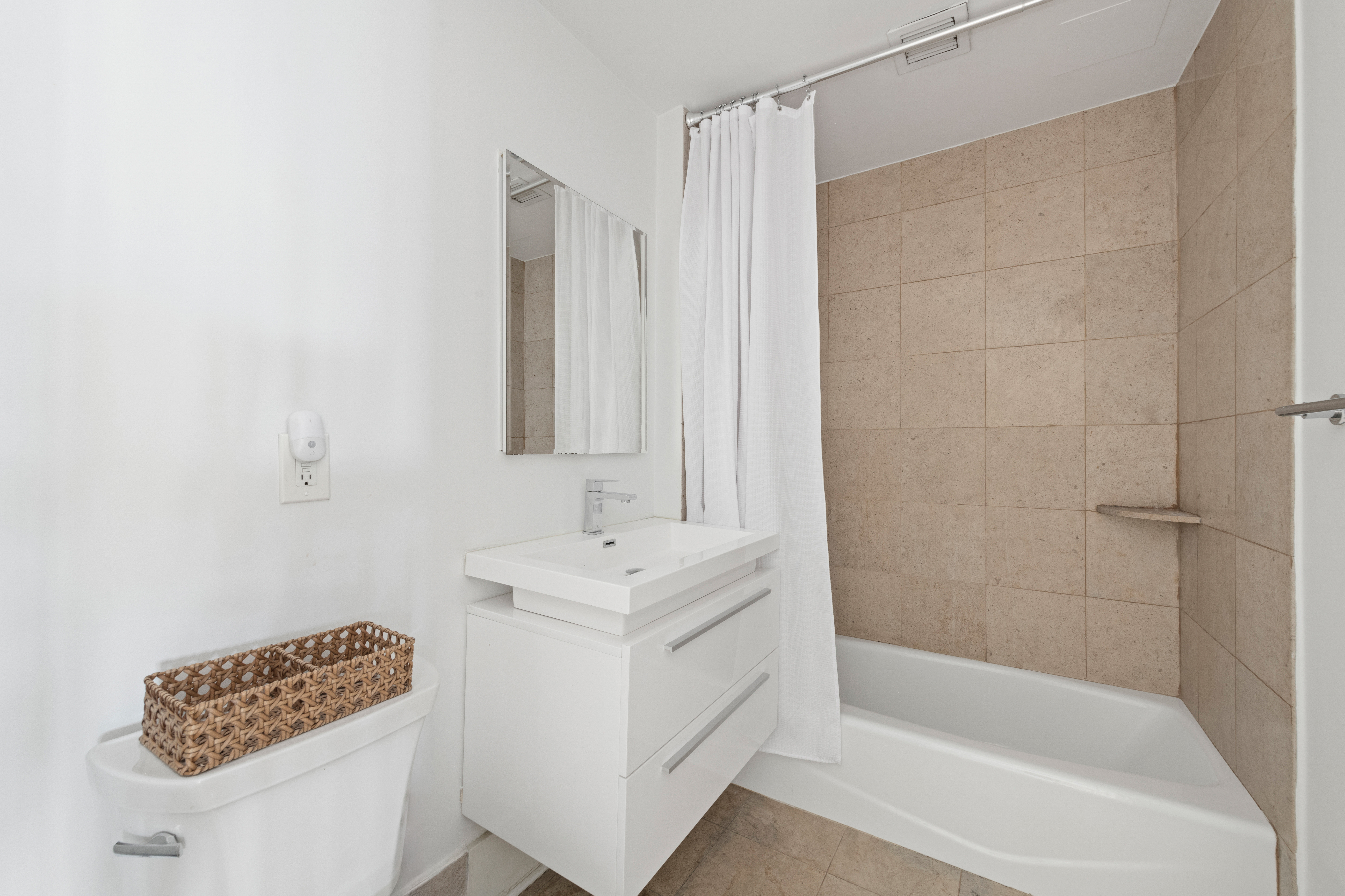 446 Kent Avenue, Unit 14A Brooklyn, NY 11249 - Photo 15 of 19 a bathroom with a bathtub a shower and a sink