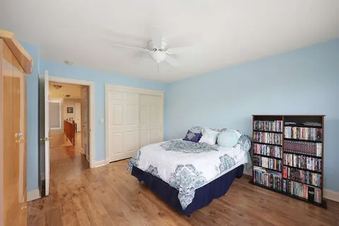 a bedroom with a bed and a bookshelf