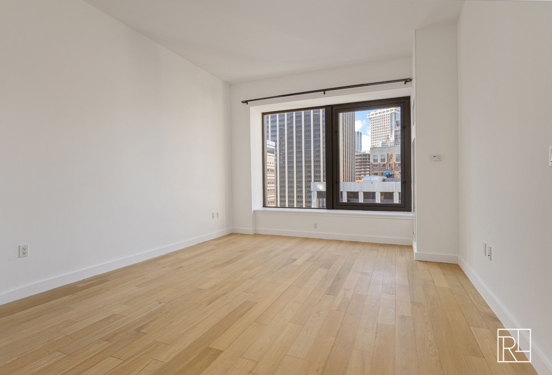 75 Wall Street, Unit 28D Manhattan, NY 10005 - Photo 12 of 35 wooden floor in an empty room with a window