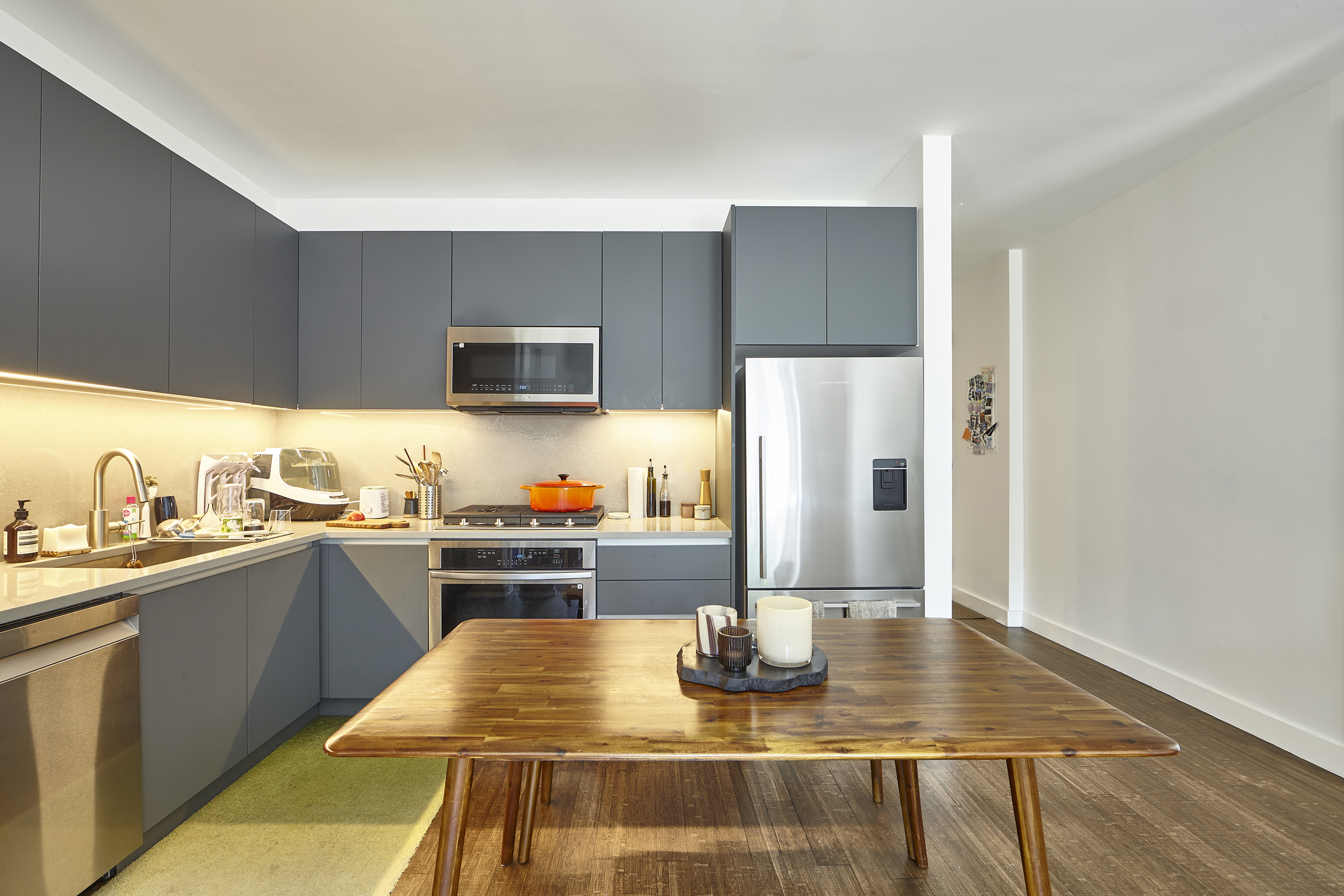 144 North 10th Street, Unit 2D Brooklyn, NY 11249 - Photo 2 of 12 a kitchen with stainless steel appliances granite countertop a sink counter space and cabinets