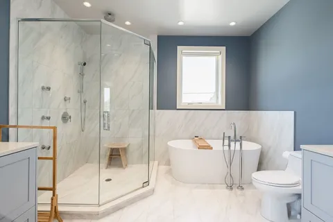 a bathroom with a shower a toilet and a sink