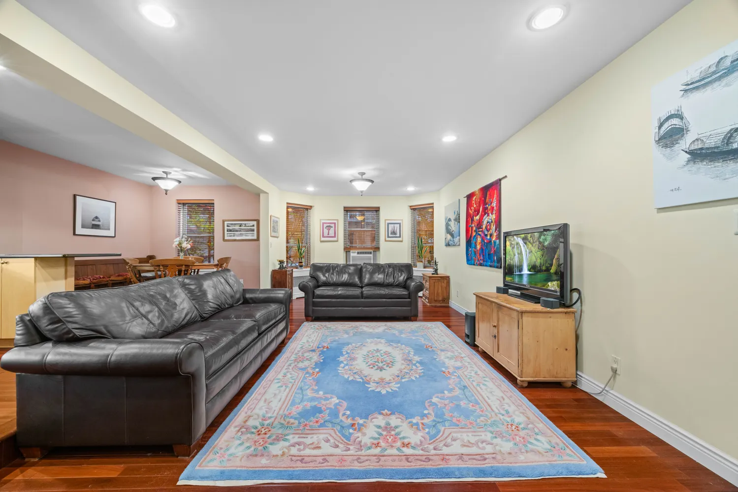 a living room with furniture and a wooden floor