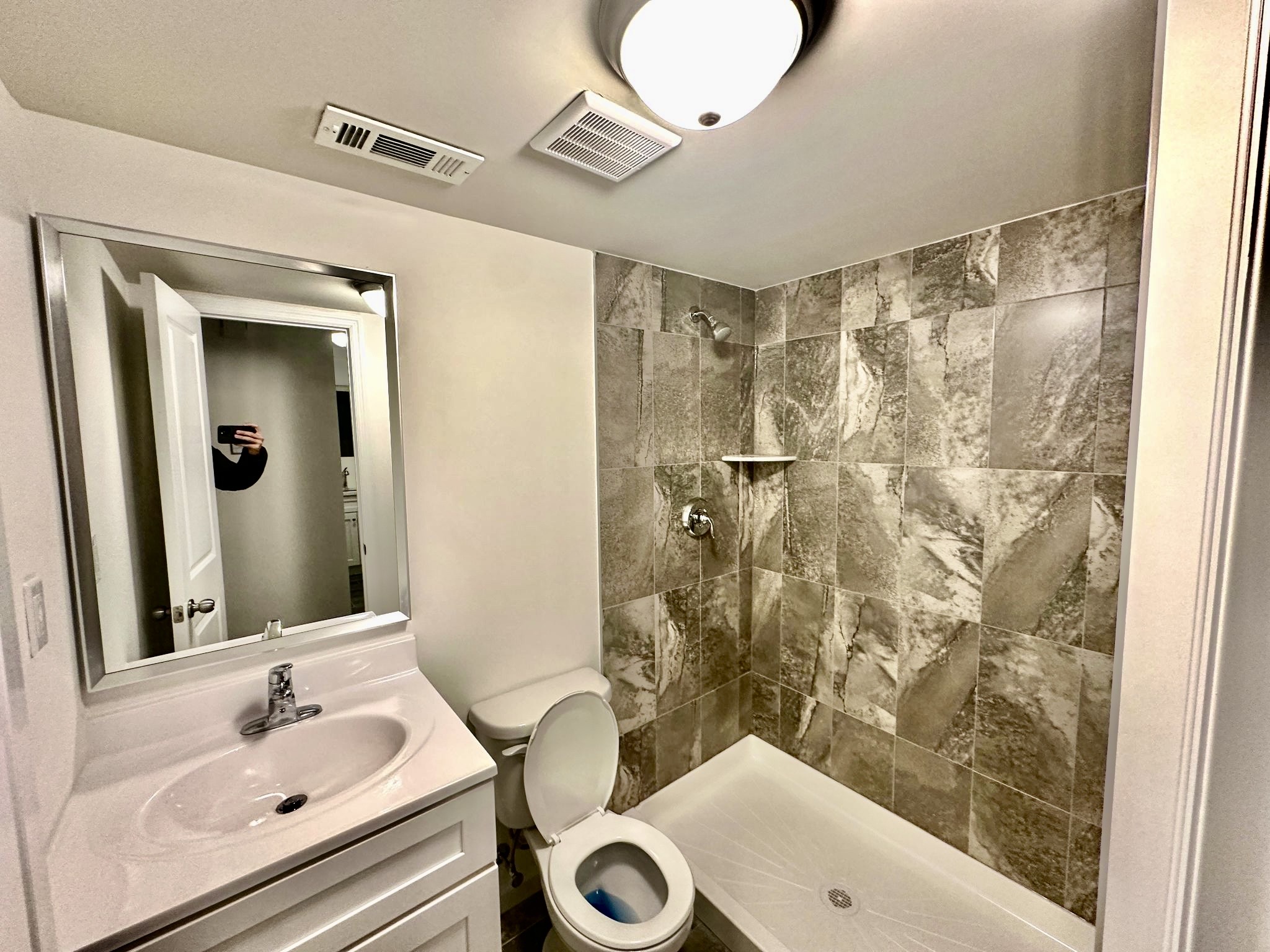 152 Davis Avenue, Unit 1 Staten Island, NY 10310 - Photo 6 of 7 a bathroom with a sink a toilet and shower