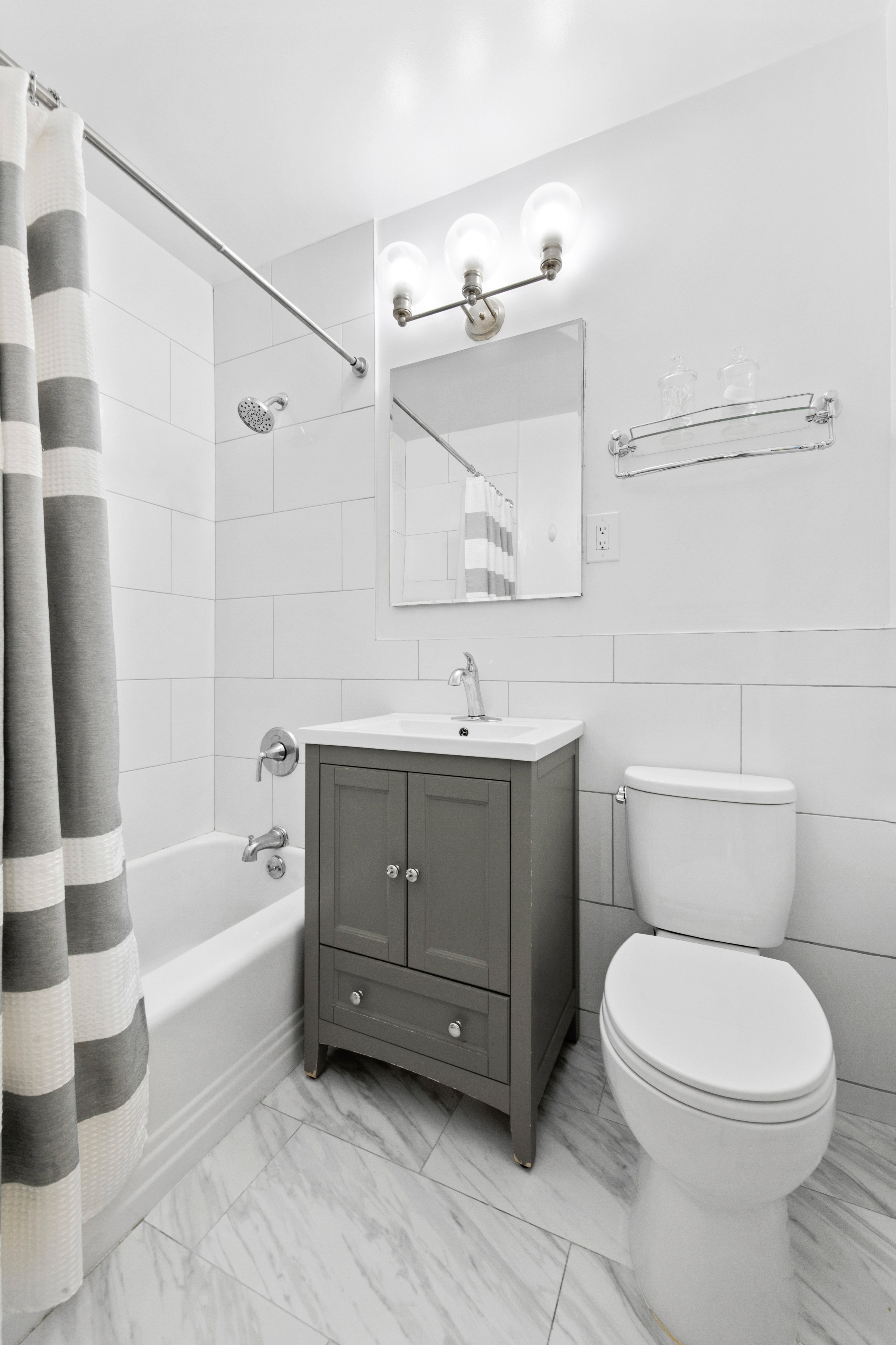 315 East 72nd Street, Unit 15M Manhattan, NY 10021 - Photo 8 of 18 a bathroom with a sink a toilet and shower