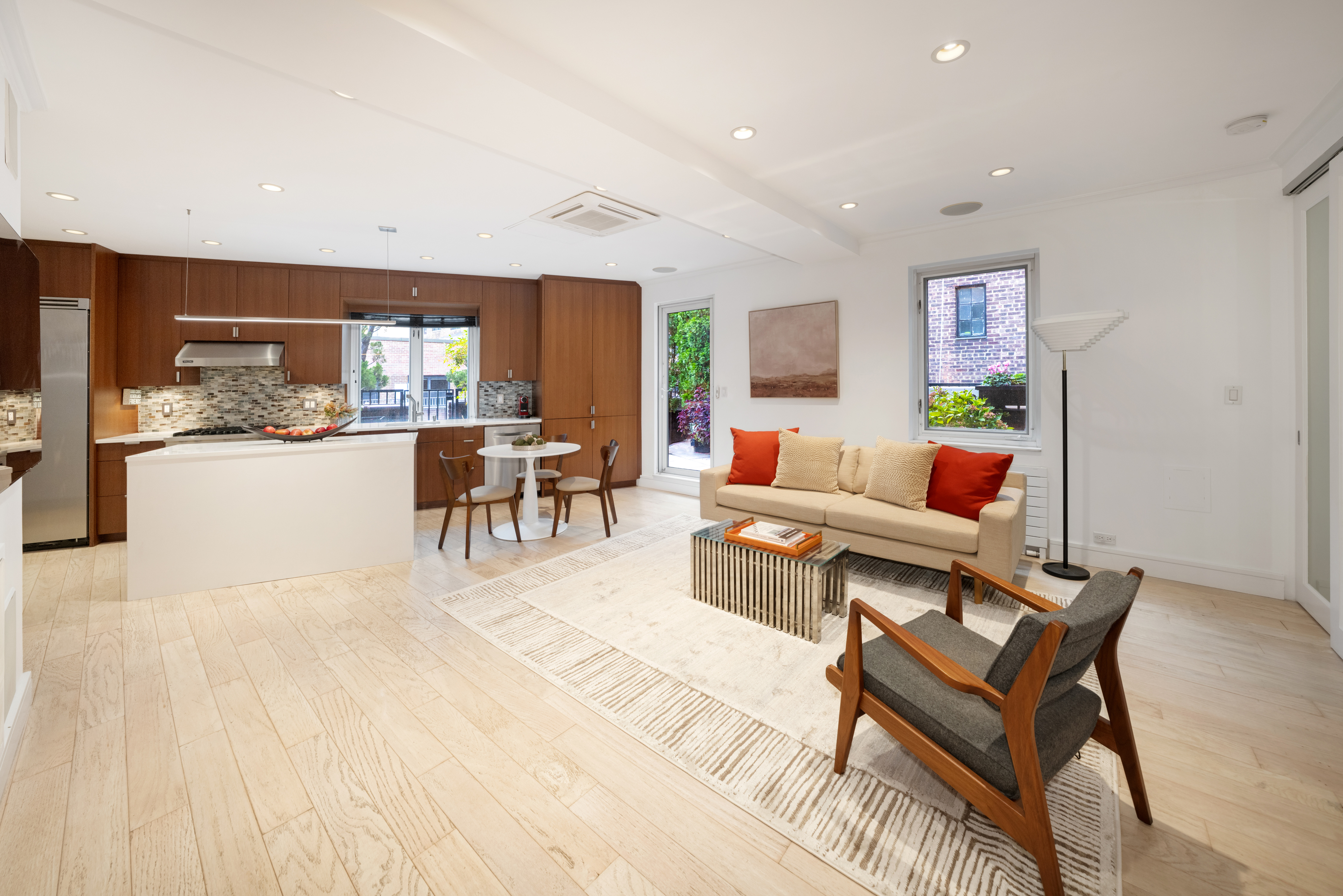 314 East 41st Street, Unit PH2B Manhattan, NY 10017 - Photo 9 of 13 a living room with furniture and a wooden floor