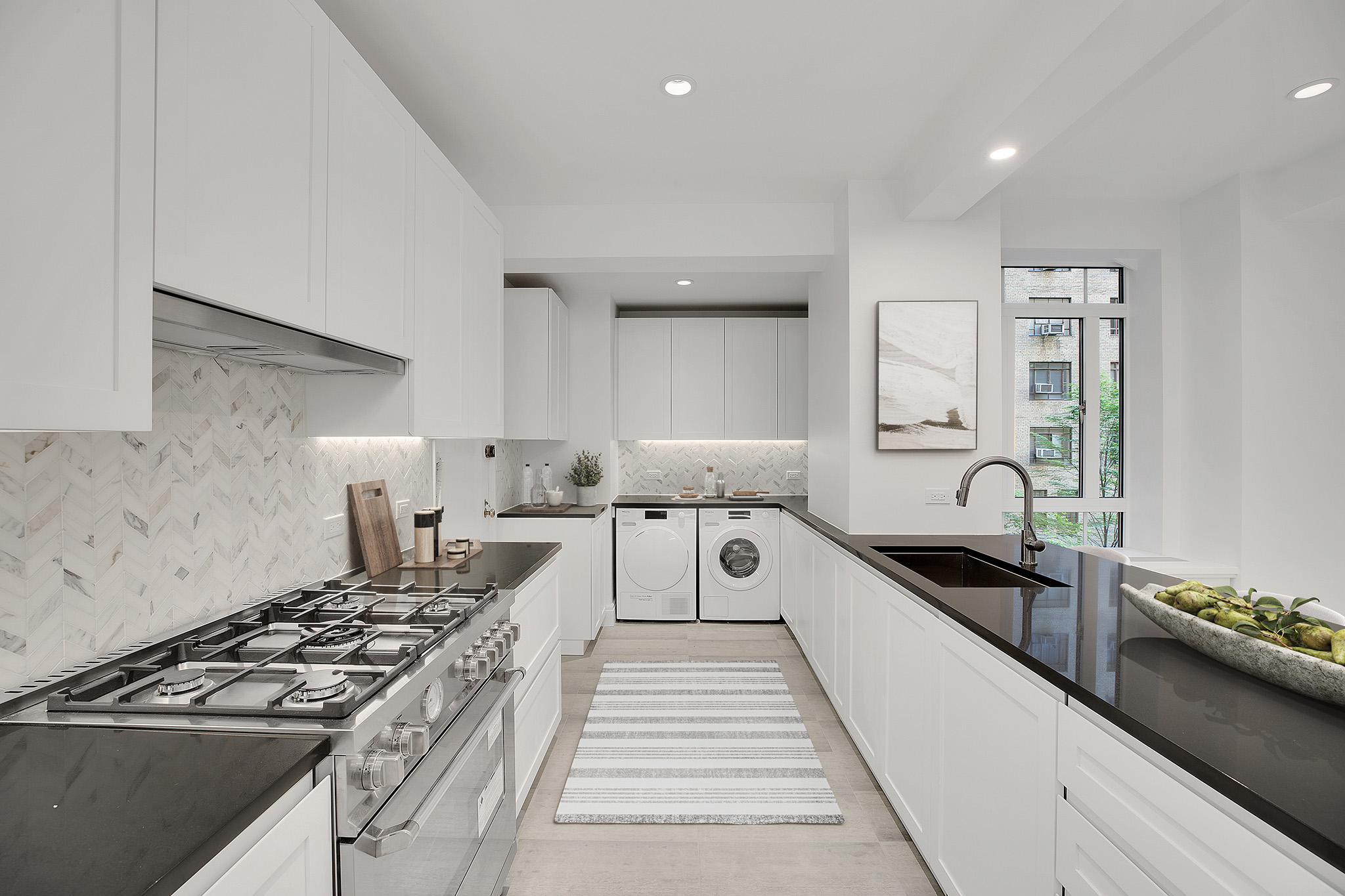 25 Central Park West, Unit 2Q Manhattan, NY 10023 - Photo 9 of 12 a large kitchen with stainless steel appliances granite countertop a lot of counter space and a sink