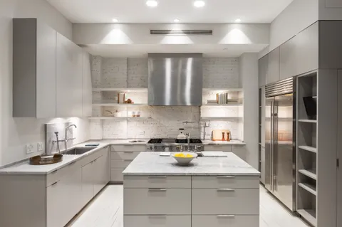 a kitchen with a sink a stove and refrigerator