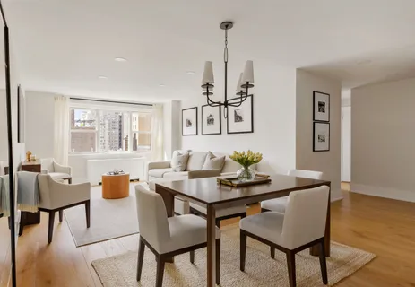 a dining room with furniture and wooden floor
