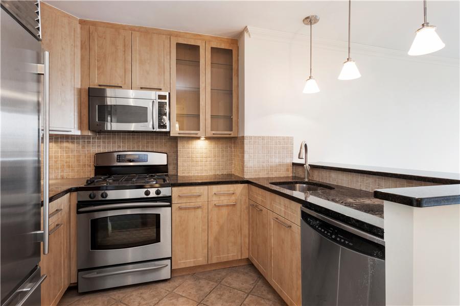 280 Park Avenue South, Unit 24E Manhattan, NY 10010 - Photo 4 of 6 a kitchen with a stove and a microwave