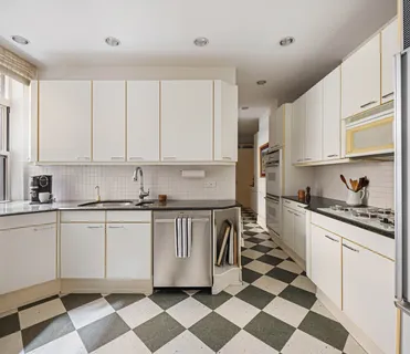 a kitchen with stainless steel appliances a stove a sink and a microwave