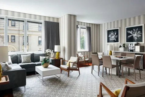 a living room with furniture and large windows