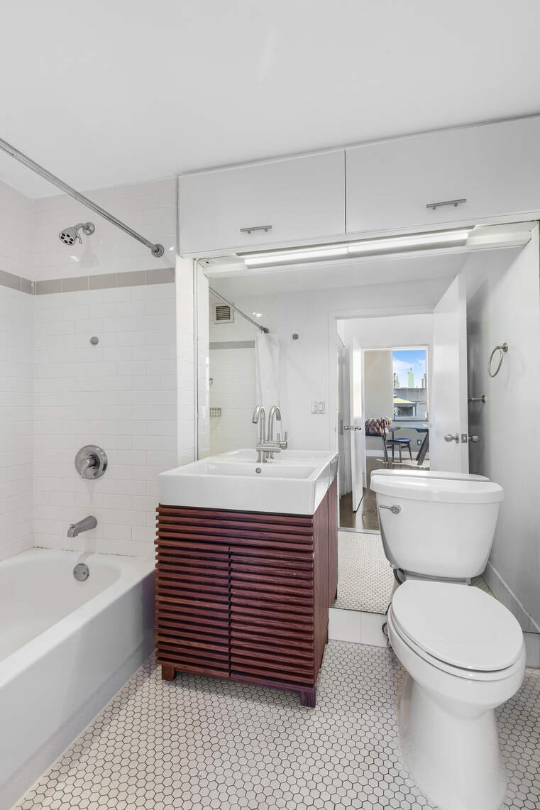 520 West 23rd Street, Unit PH16F Manhattan, NY 10011 - Photo 4 of 17 a bathroom with a sink a toilet and bathtub