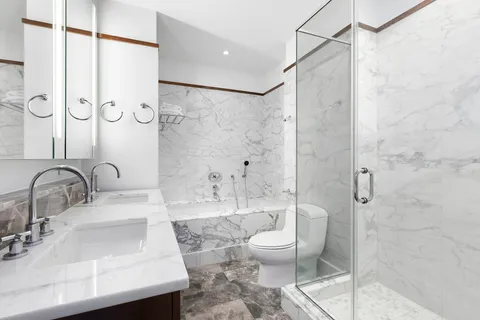 a bathroom with a sink toilet and shower