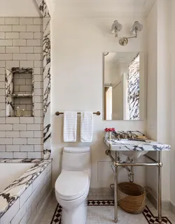 a living room with a couch and a potted plant