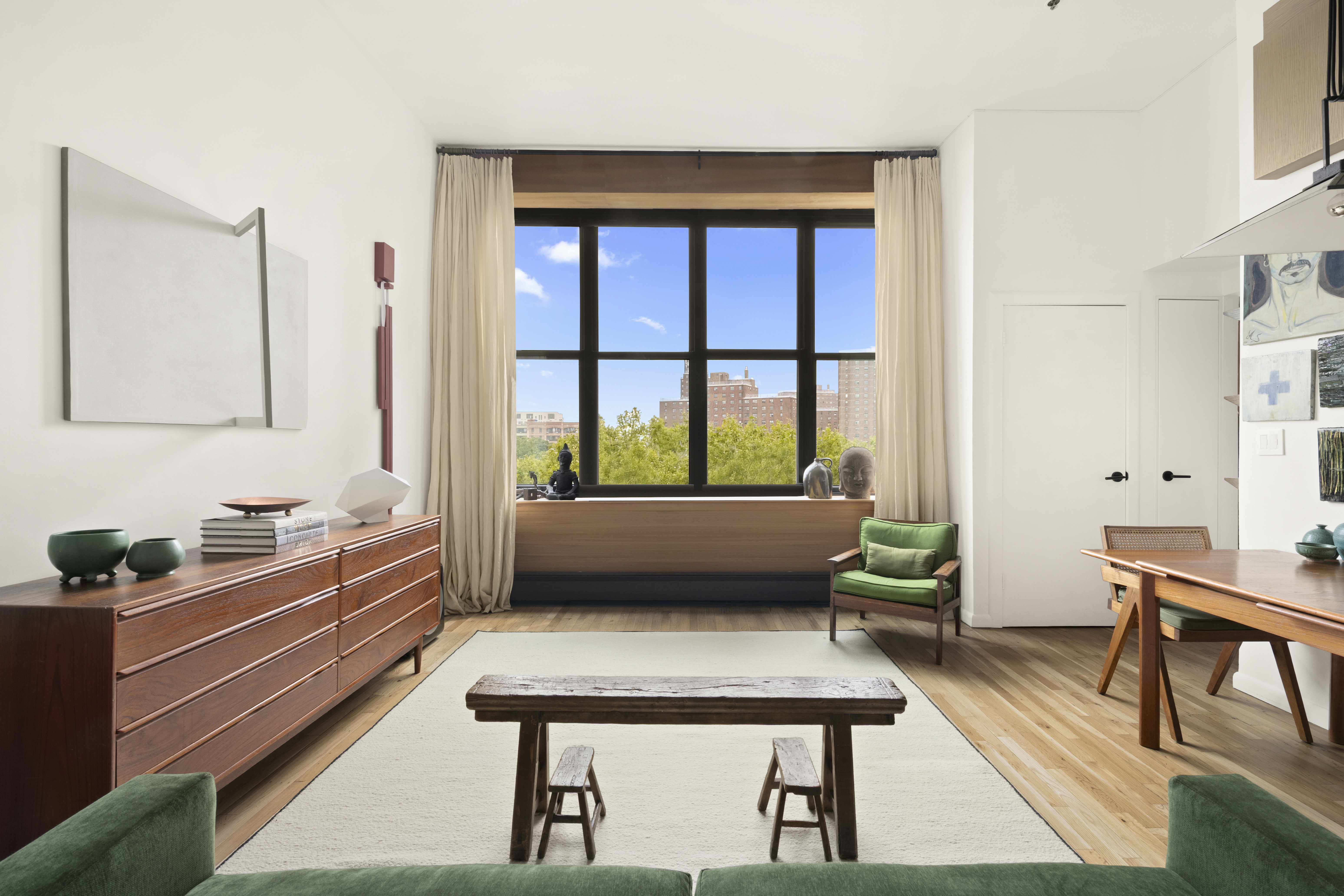 a living room with a couch and a potted plant