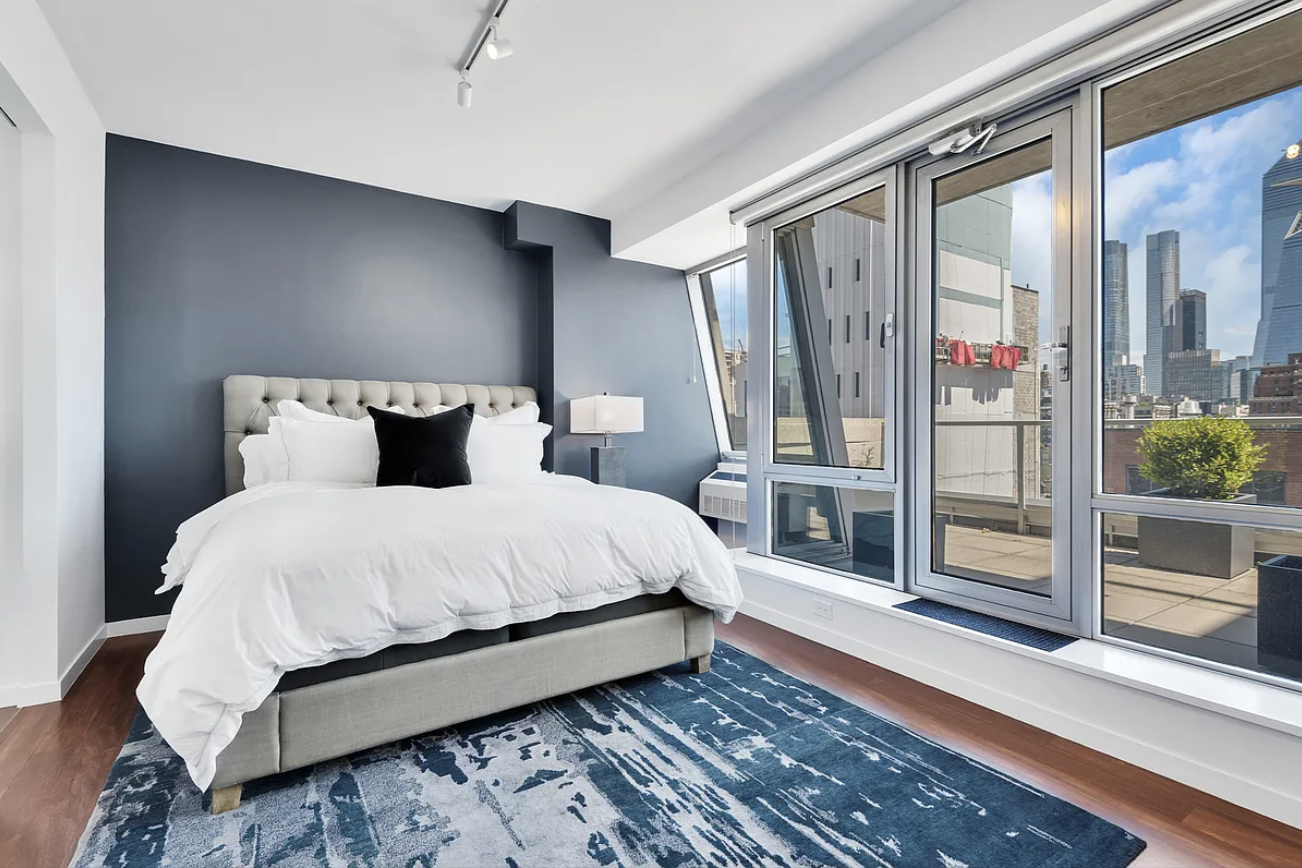 444 West 19th Street, Unit PH1 Manhattan, NY 10011 - Photo 4 of 8 a bedroom with a large bed and a window