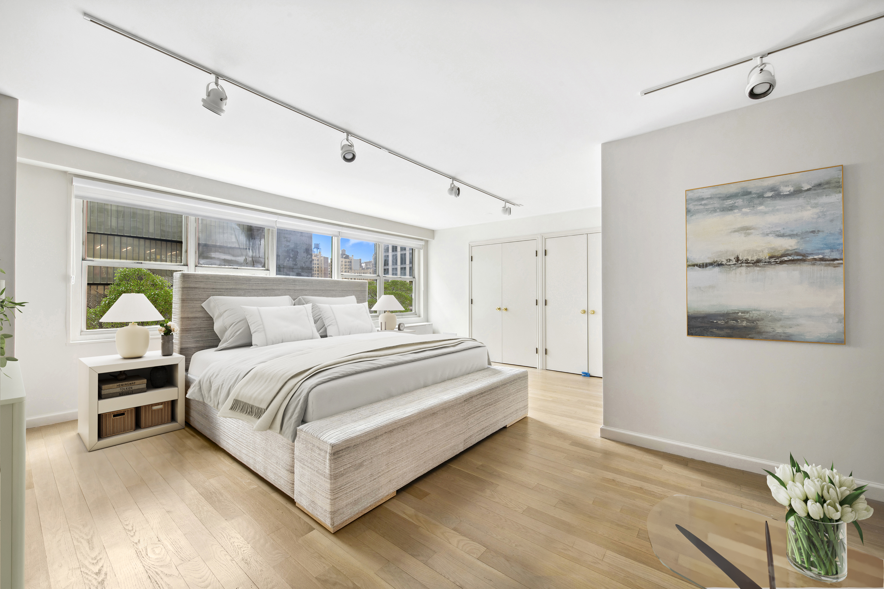 155 West 68th Street, Unit 404 Manhattan, NY 10023 - Photo 10 of 21 a bedroom with a bed and a painting on the wall