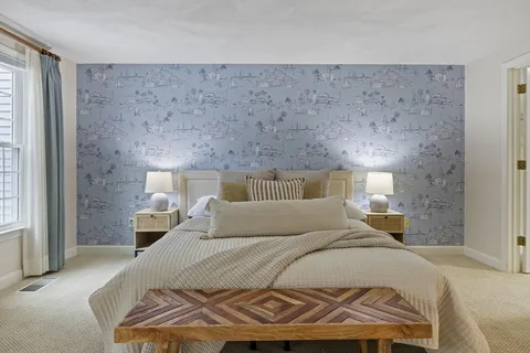 a bedroom with a bed and a night stand